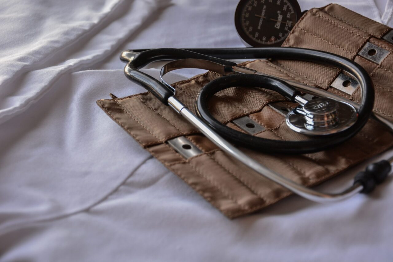 A stethoscope in a brown bag on a white sheet