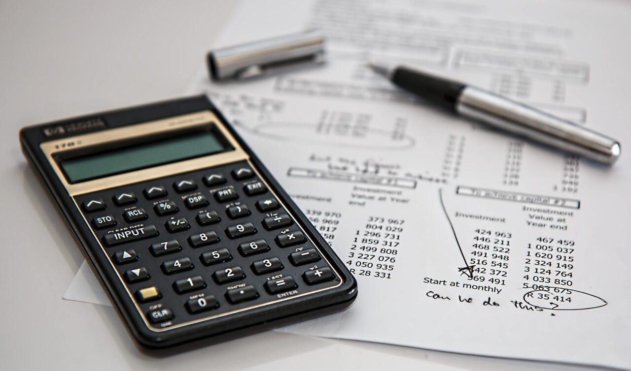 Calculator and pen on a financial spreadsheet