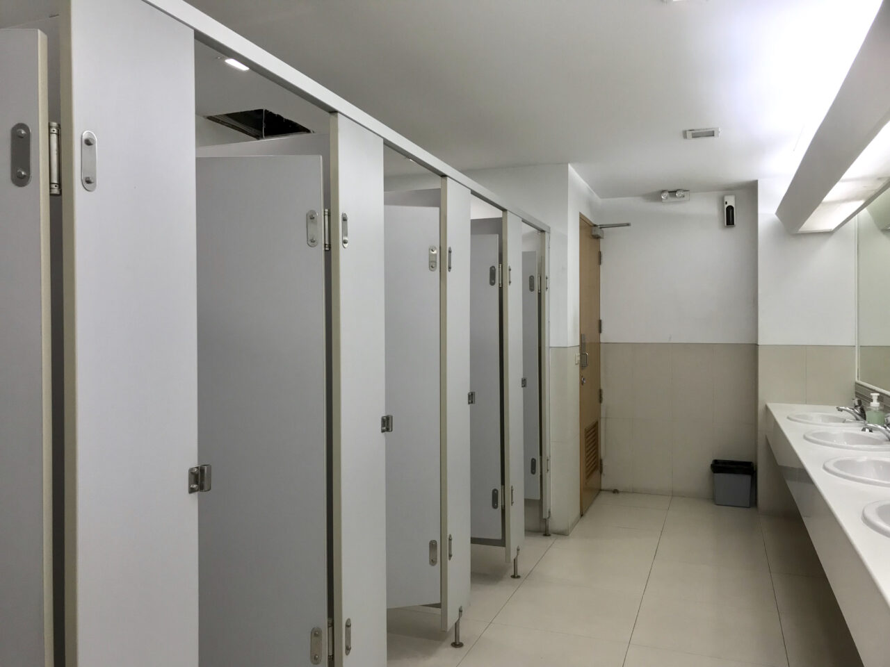 A public bathroom with the stalls open
