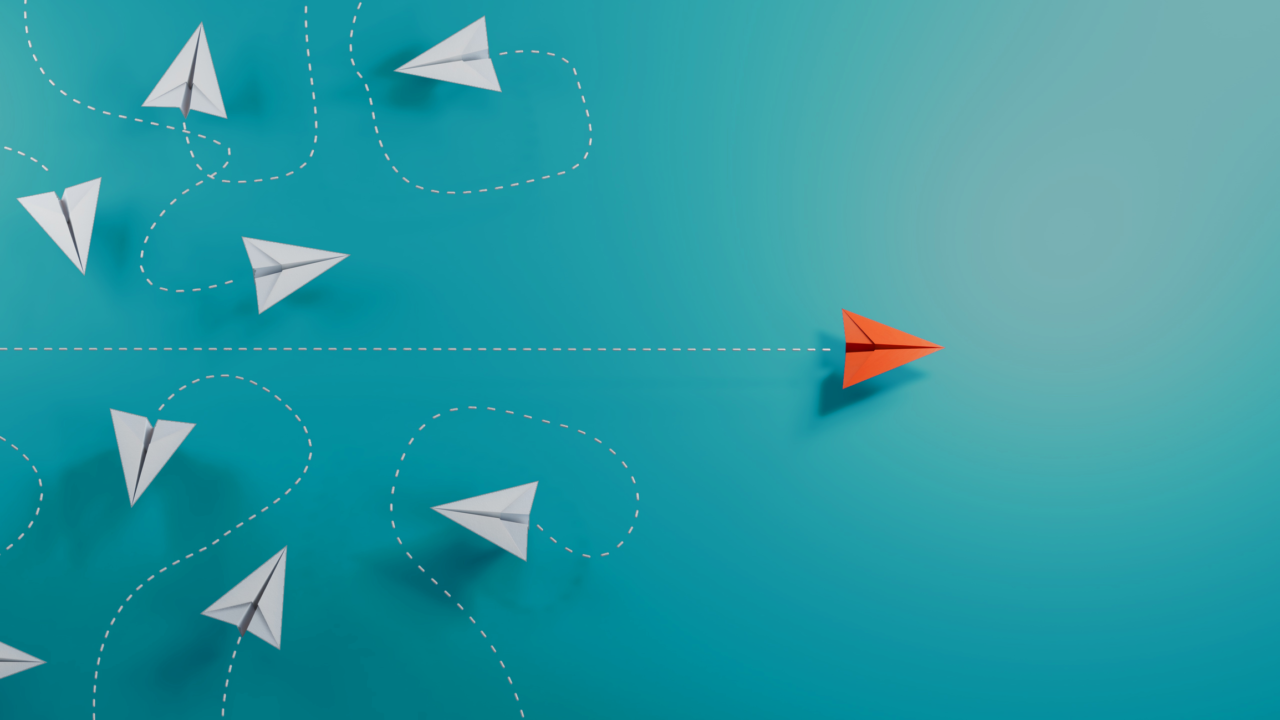 Orange paper aeroplane moving forward with clear direction